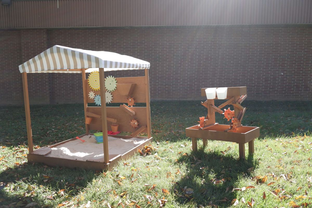 Covered sand table and water table on the play field at Newark Nature School, Newark, DE